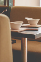 Retro style dining room interior details. White plate on the table
