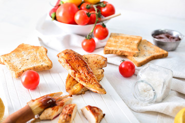 Tasty roasted chicken with barbecue sauce on white table