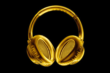 Golden shiny wireless headphones on black background isolated close up, luxury gold metal bluetooth...