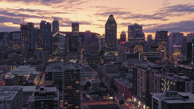 Aerial flying over the Montreal City Skyline at sunset. Quebec, Canada. 