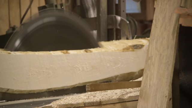 Logging wood mill in Northern Michigan with piles of logs getting cut into lumber wood planks how boards are made at factory