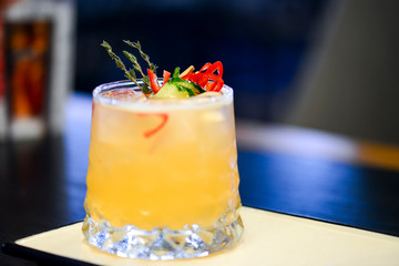 Cocktail on a white plate. Cold citrus alcohol beverage with tequila served with ice, copy space.