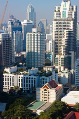Fototapeta premium Bangkok, Thailand – December 21, 2019 : Office Buildings, city and condominiums Area in Bangkok, Office Building in City, Modern Building, Businesses Building. Sky view from Asoke area. with blue sky.