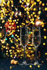 Champagne in the the glass against the background of the christmas tree, New Year Christmas. New year concept 2020