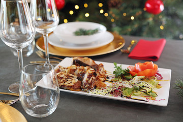 Carp in almonds, Christmas dish. Traditional Christmas dishes, festive table setting. Horizontal composition.