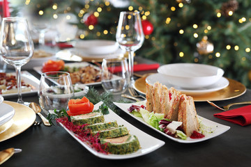 Festive dishes on an elegant table. Christmas dishes, festive table setting. Horizontal composition.