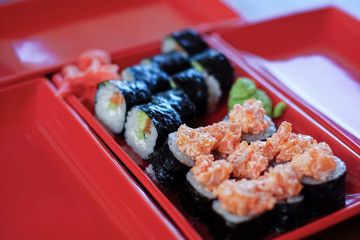 Traditional sushi rolls set with ginger and wasabi sauce, close up, selective focus. Japanese cuisine.
