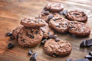 Fototapeta na wymiar Tasty chocolate chip cookies on wooden background