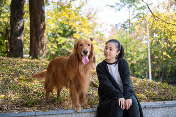 The woman and her golden retrieval dog are friendly.