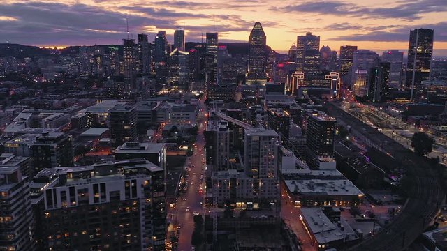 Aerial flying over the Montreal City Skyline at sunset. Quebec, Canada. 