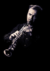 Saxophonist on black background