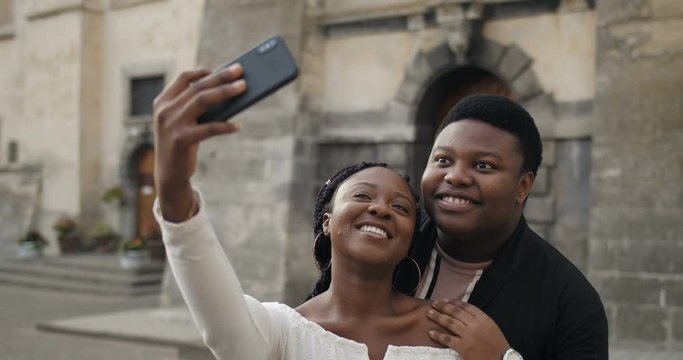 Young couple posing on smartphone.