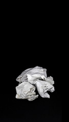 Crumpled paper white ball isolated on a black background
