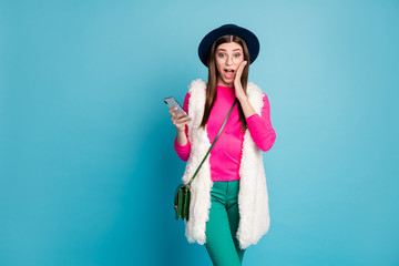 Portrait of her she nice-looking attractive lovely fashionable cheerful amazed girl using device incredible sale discount isolated on bright vivid shine vibrant green blue turquoise color background
