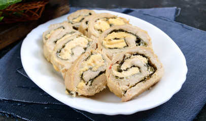 Obraz na płótnie Canvas Baked turkey rolls with spinach, mozzarella on plate. Healthy tasty lunch. New Year and Christmas appetizer.