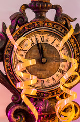 Vintage clock with colorful serpentine stripes and gift boxes. New Year concept