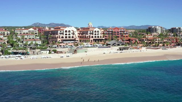 Hotel resorts on Cabo San Lucas coast, Mexico, sliding truck drone 4k