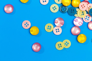 collection of various colored buttons on colored background