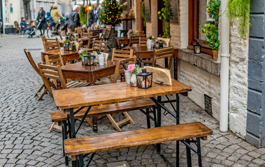 Selective focus on outdoor tables and chairs in the street outside a cafe in the Dutch town of Maastricht