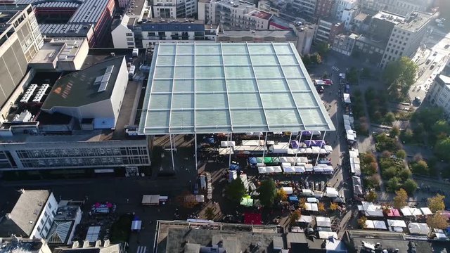 Aerial footage of the famous Antwerp Vogelenmarkt or bird market which originated in the 16th century on the Meir and was originally a place where poultry small livestock and venison were bought 4k