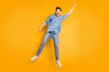 Fototapeta na wymiar Full length body size photo of cheerful screaming positive man in white footwear flying away with umbrella by wind blowing isolated vivid color background