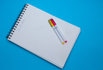 To-Do list,new years resolution, 2020! notebook and a pen, on a blue background