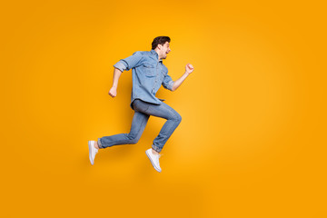 Fototapeta na wymiar Side profile photo of cheerful positive man screaming after seeing sales beginning isolated in white footwear over vivid color background
