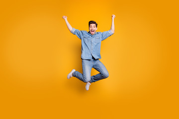 Fototapeta na wymiar Full length body size photo of brown haired crazy excited rejoicing man jumping up screaming isolated over yellow vivid color background