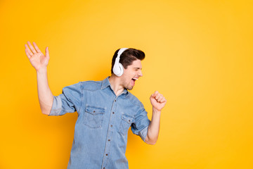 Photo of crazy singer screaming into imaginary microphone using wireless headphones for listening...