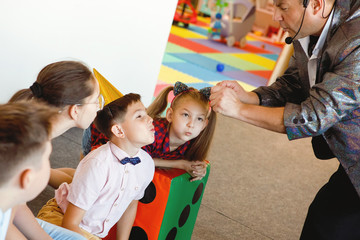 Illusionist shows tricks to teens on birthday.