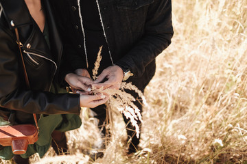 Portrait of Happy Couple Dressed in Black Stylish Clothes Enjoying a Good Time Walking on the Field