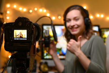 Actively, the girl talks to her viewers on a video camera. Record of vlogs, YouTube