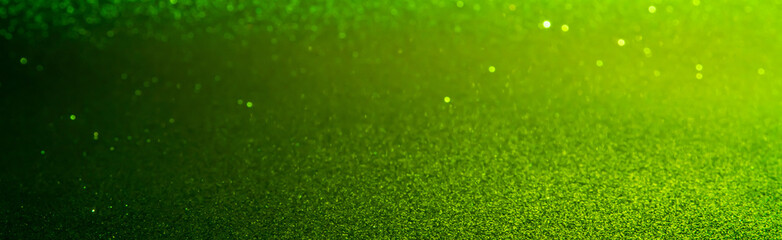 green Sparkling Lights Festive background with texture. Abstract Christmas twinkled bright bokeh...