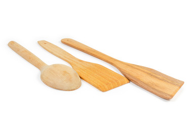 Two wooden kitchen spatulas and spoon on white background closeup