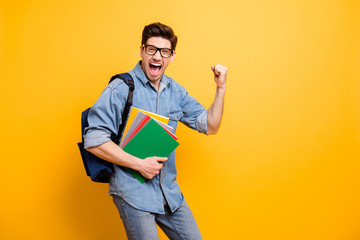 Photo of cheerful excited crazy man saying yeah screaming passing exam with satchel behind...