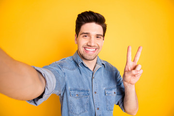 Photo of cheerful positive attractive man showing you v-sign smiling toothily brown haired taking...