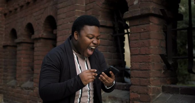 Man celebrating good news and funny dancing.