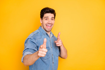 Photo of cheerful positive handsome man with good mood pointing at you to praise you smiling...