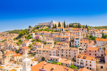 Croatia, beautiful old city of Sibenik, panoramic view of the town center, houses on hills and fortress of St Michael over the city
