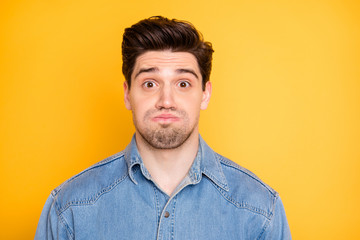 Close-up portrait of his he nice attractive handsome funky comic guy holding air in cheeks grimacing isolated over bright vivid shine vibrant yellow color background