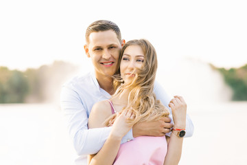 Portrait of a beautiful couple in love. They are happy and hugging. The wind in your hair girls