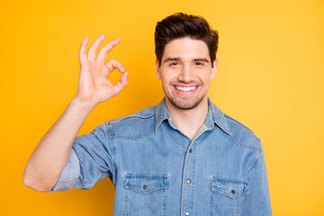 Portrait of positive cheerful guy promoter show okay sign advise promo ads wear casual style clothing isolated over yellow color background - obrazy, fototapety, plakaty