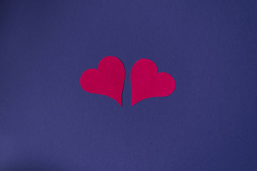 Two paper hearts on a blue background. Copy space