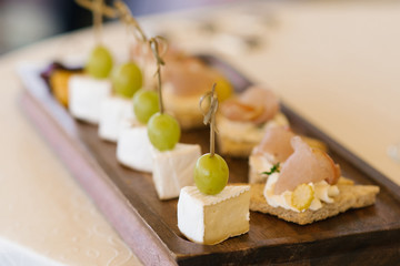 Appetizer of cheese and grapes on a skewer at the festive buffet