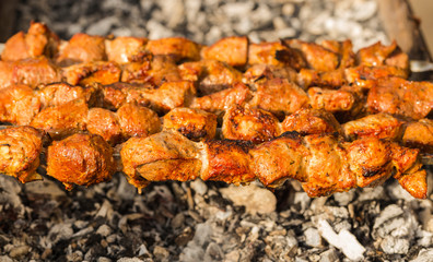 Meat slices prepare on fire. Baked meat on skewers.