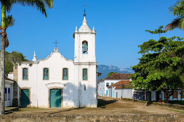 Arial view of church Nossa Senhora das Dores (Our Lady of Sorrows) wit trees on a sunny day, historic town Paraty, Brazil