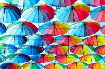 Hanging multicolored colorful umbrellas adorn the alley, street decoration