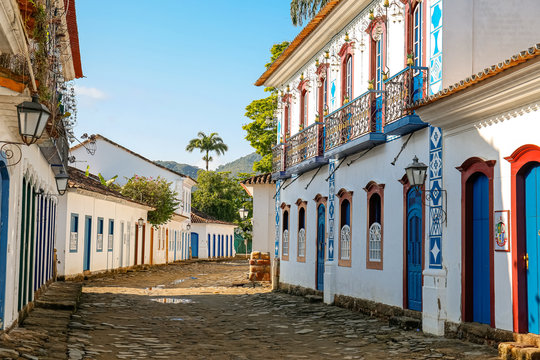 View to a cobblestone street with artful decorated house facades in historic town Paraty, Brazil