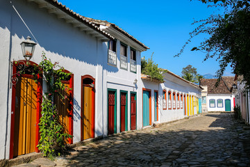 Typical cobblestone street with colorful colonial buildings in the late afternoon sun in historic town Paraty, Brazil