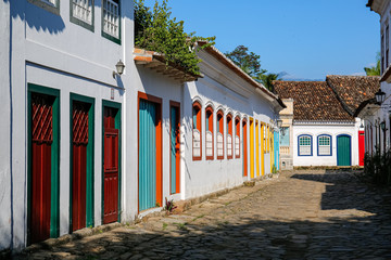 Typical cobblestone street with colorful colonial buildings in the late afternoon sun in historic town Paraty, Brazil